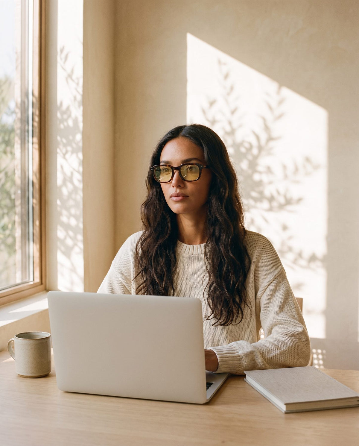 Woman at a sunlit desk wearing Flow Day in Tortoise