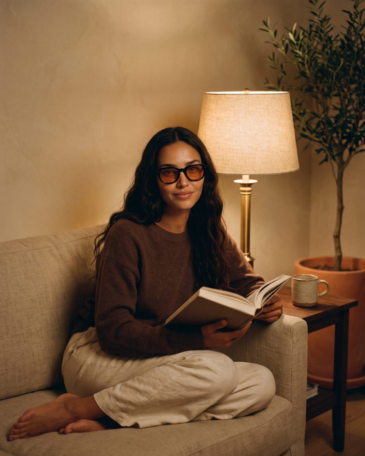 The same woman on the couch at night wearing Flow Evening in Black